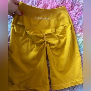 alphalete amplify biker short in golden hour yellow color size medium activewear
